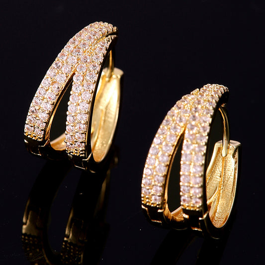 Lilyah Jewelry Gold Plated Diamond Earrings. Double hoop earrings with clear gemstones on a black background