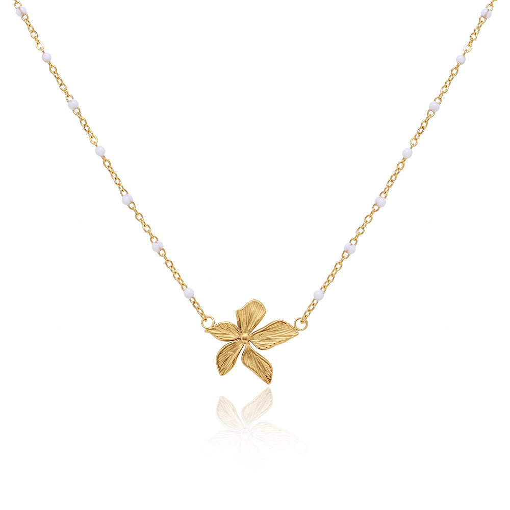 18k Gold plated flower necklace on a white background.