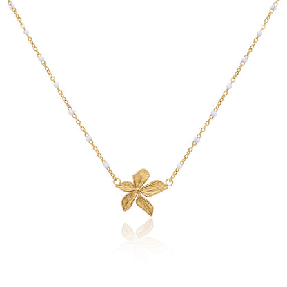 18k Gold plated flower necklace on a white background.
