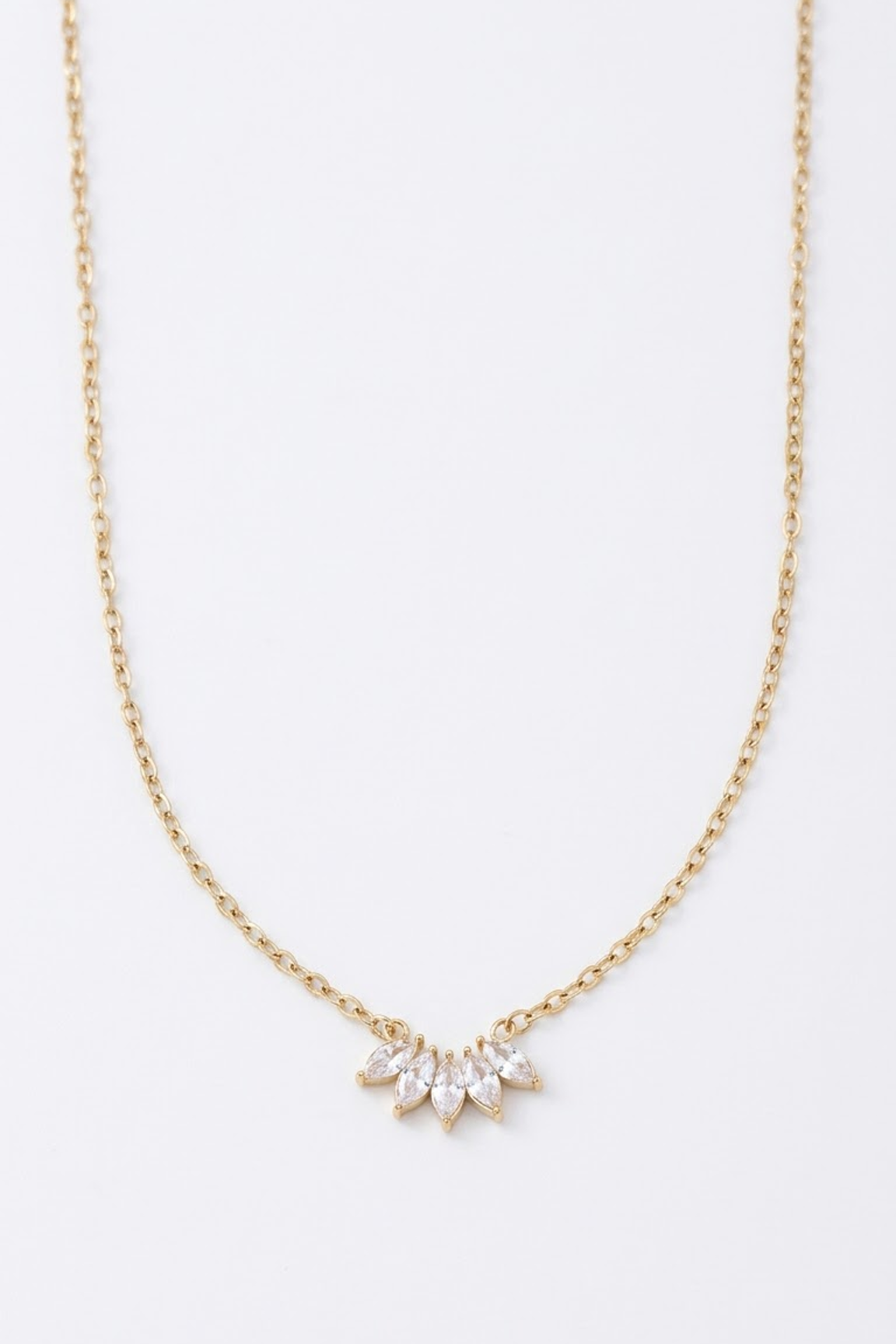 A delicate 18k gold plated chain necklace from Lilyah Jewelry featuring a small sunburst pendant made of clear marquise-cut rhinestones, displayed against a clean white background.