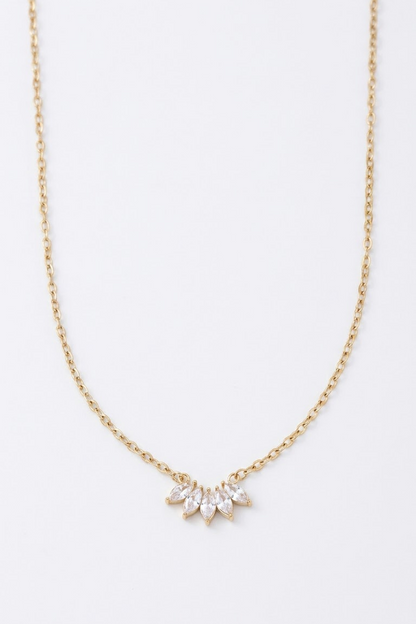 A delicate 18k gold plated chain necklace from Lilyah Jewelry featuring a small sunburst pendant made of clear marquise-cut rhinestones, displayed against a clean white background.