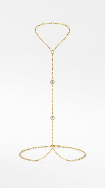 Lilyah Jewelry's delicate 18k gold plated body chain featuring two small diamond-shaped links set with clear stones, suspended from a matching circular chain at the wrist and finger, photographed on a clean white background.