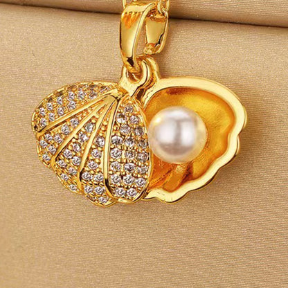 Lilyah Jewelry's 18k Gold plated shell pendant necklace featuring a artificial white pearl and clear rhinestones, displayed on a beige textured background.