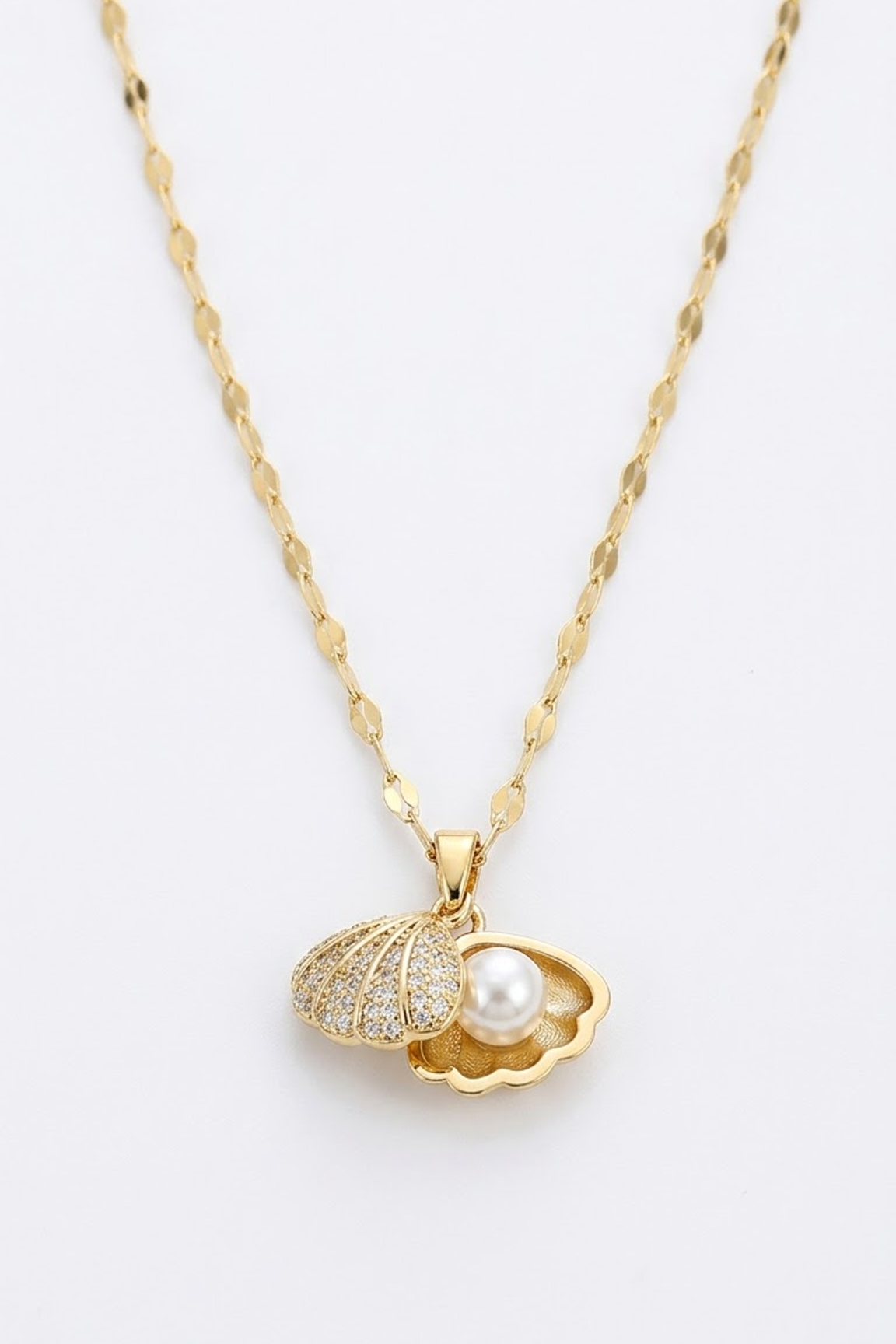Lilyah Jewelry's 18k gold plated chain necklace with a pendant shaped like an open shell, one half paved with small clear stones and the other holding a white pearl, shown on a plain white background.