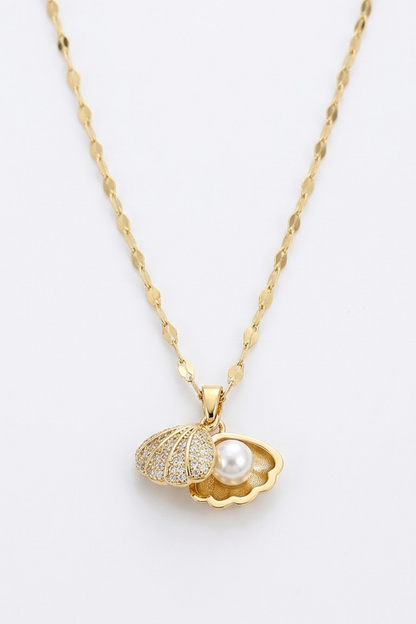 Lilyah Jewelry's 18k gold plated chain necklace with a pendant shaped like an open shell, one half paved with small clear stones and the other holding a white pearl, shown on a plain white background.