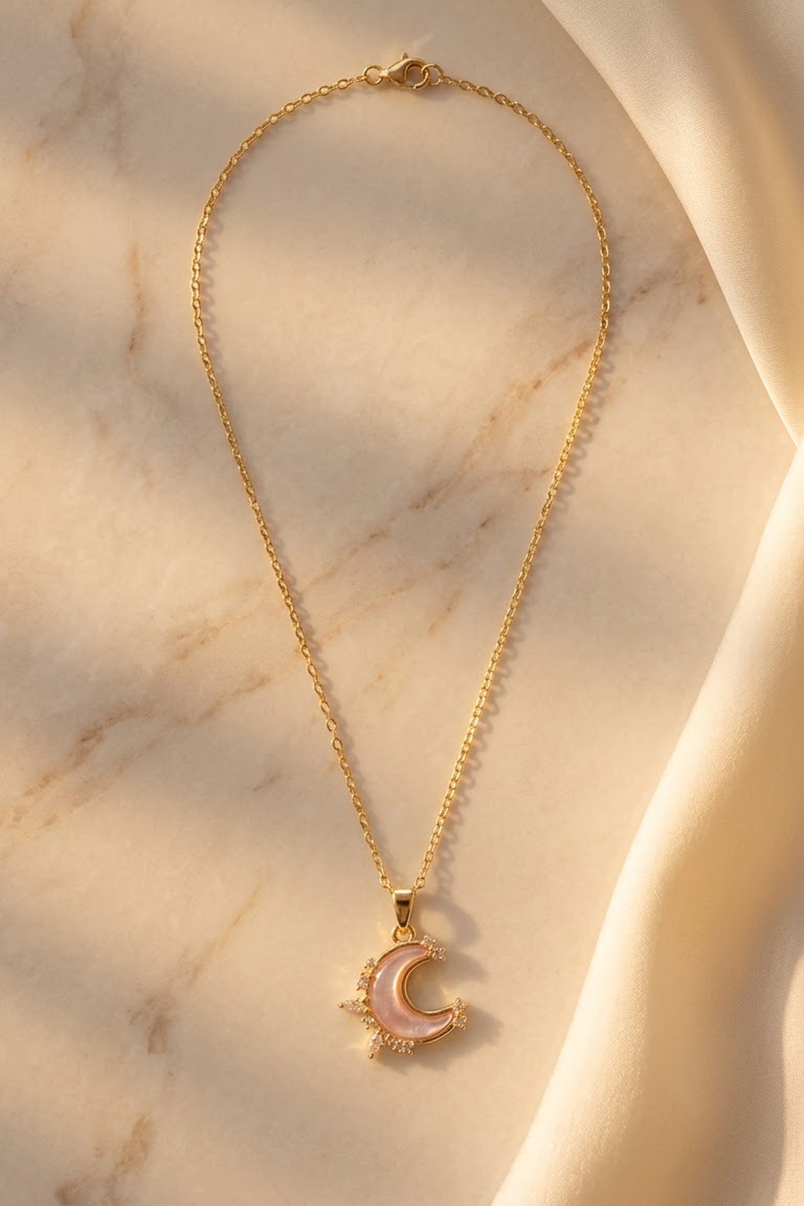 Lilyah Jewelry's 18k Gold plated pink moon necklace inspired by the korean necklaces and pinterest.