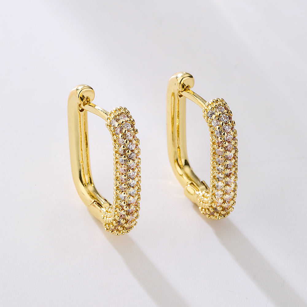 A pair of 18k gold plated rectangular hoop earrings with zircon inlays on a white background. Lilyah Jewelry Gold Plated Earring. Gift Ideas for her.