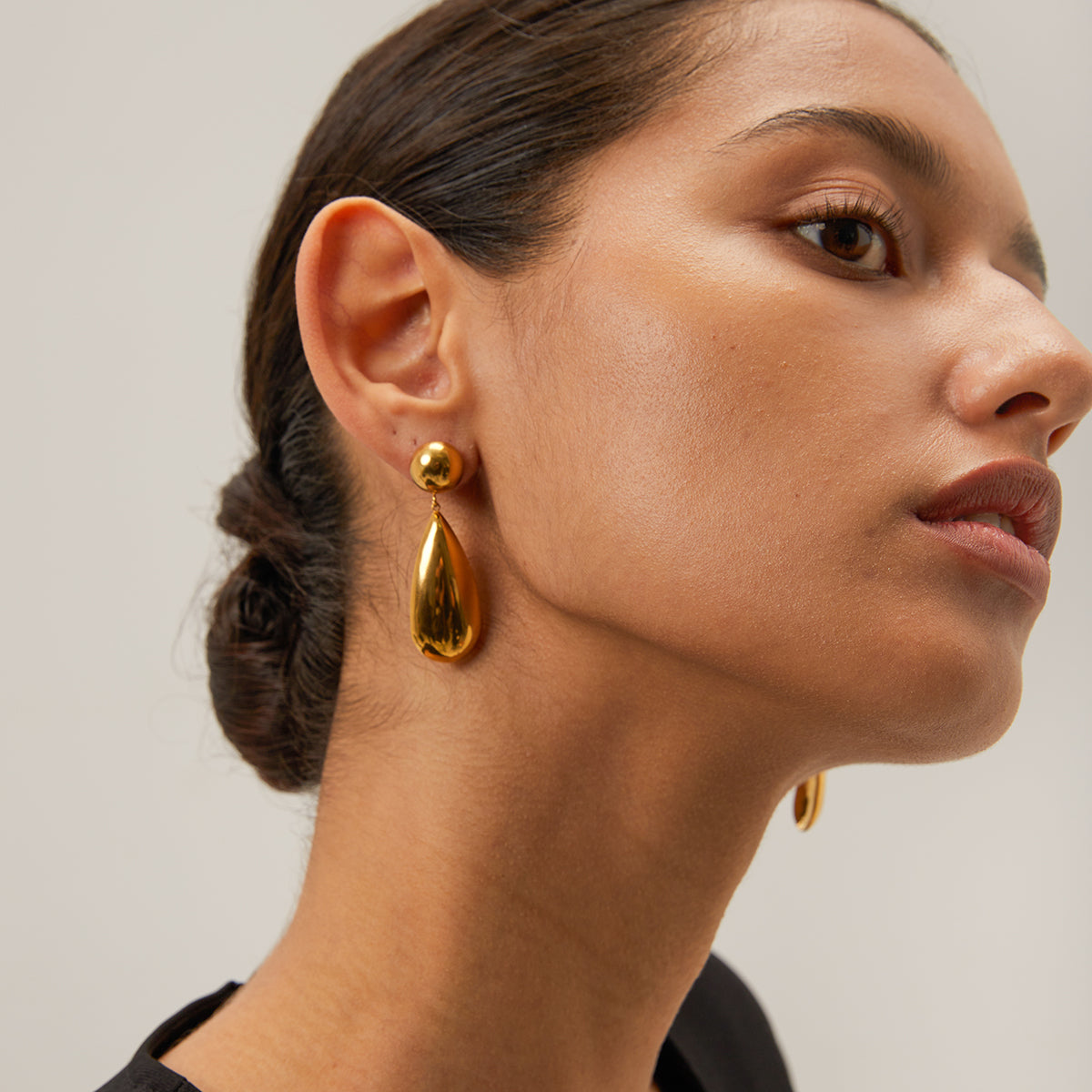 A person wearing 18k gold plated sphere and teardrop drop earrings. Lilyah Jewelry Gold Plated Earring. Gift Ideas for her.