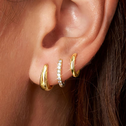 A close-up image of a person's ear wearing a gold-plated hoop earring with a zircon inlay. Lilyah Jewelry Gold Plated Earring. Gift Ideas for her.