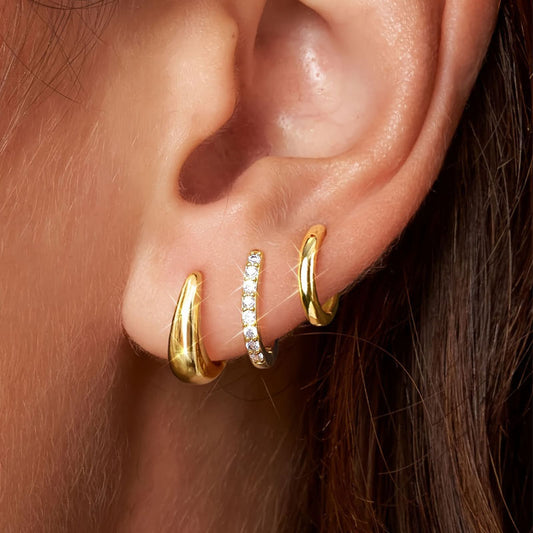 A close-up image of a person's ear wearing a gold-plated hoop earring with a zircon inlay. Lilyah Jewelry Gold Plated Earring. Gift Ideas for her.