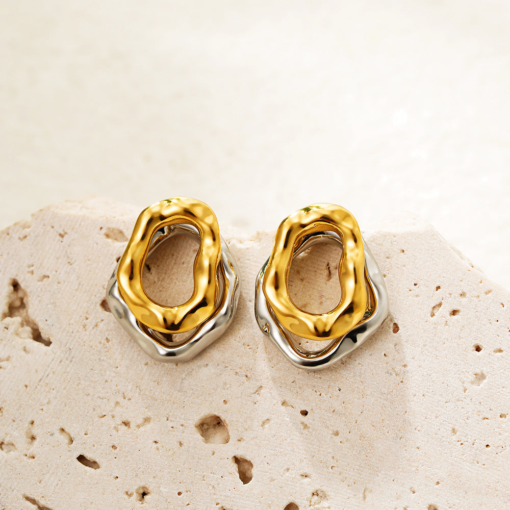 Lilyah Jewelry Gold Plated Earrings.  Gold and silver earrings on a textured beige surface