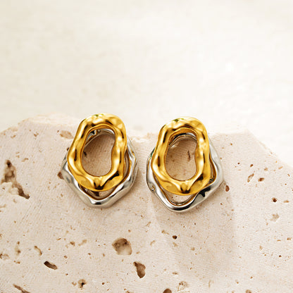 Lilyah Jewelry Gold Plated Earrings.  Gold and silver earrings on a textured beige surface