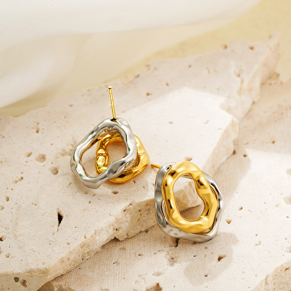 Lilyah Jewelry Gold Plated Earrings.  Gold and silver earrings on a textured beige surface