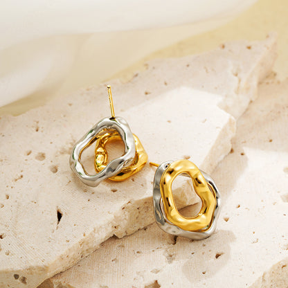 Lilyah Jewelry Gold Plated Earrings.  Gold and silver earrings on a textured beige surface