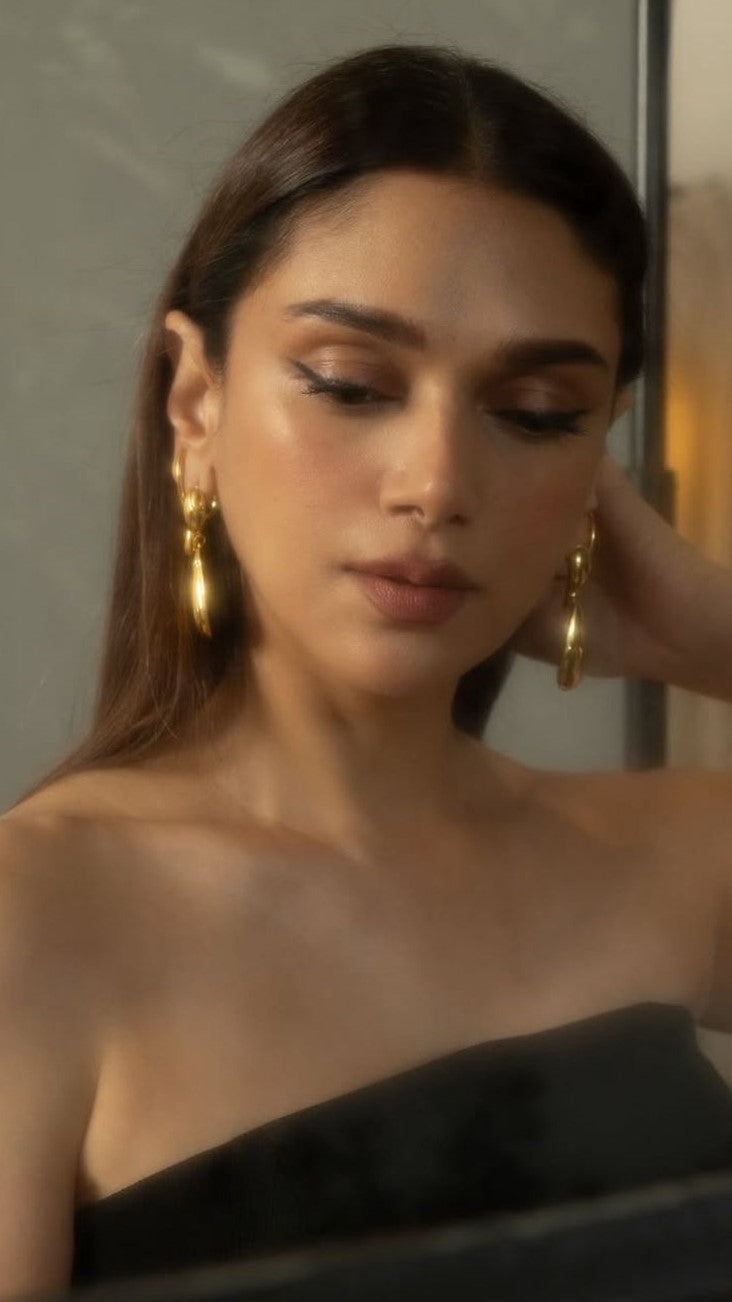 Woman wearing gold earrings with a neutral background. Lilyah Jewelry Gold Plated Earring. Gift Ideas for her.